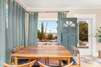 a dining room with a wooden table and chairs at Ocean View, Hot Tub, Sauna, Beach Bikes in Ventura