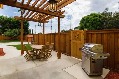 a patio with a table and a grill and a table and chairs at Historic craftsman sleeps 9 3br2.5ba Disney 1mi in Anaheim