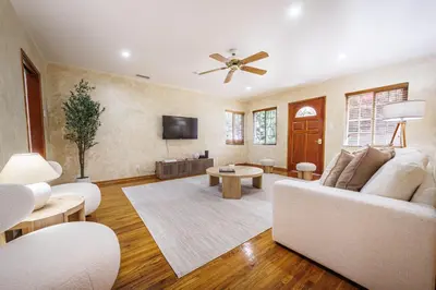 a living room with a white couch and a ceiling fan at Santa Monica 2BD Home - 20 mins to LAX Airport! in Los Angeles