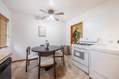 a kitchen with a table and a ceiling fan at Santa Monica 2BD Home - 20 mins to LAX Airport! in Los Angeles
