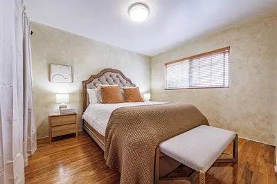a bedroom with a large bed and a window at Santa Monica 2BD Home - 20 mins to LAX Airport! in Los Angeles