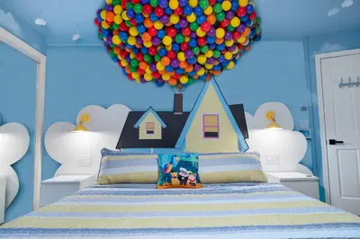 a room with a bed with a balloon above it at Imagination Kingdom by OC Adventure Homes in Garden Grove