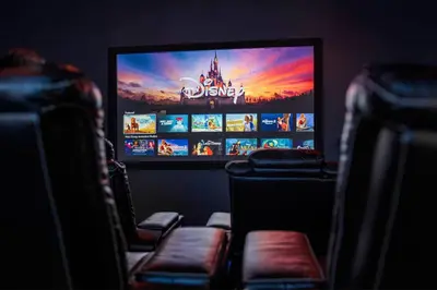 a flat screen tv sitting in a room with chairs at Imagination Kingdom by OC Adventure Homes in Garden Grove