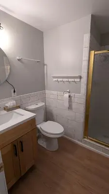 a bathroom with a toilet and a sink and a shower at Serene home in Simi valley, CA in Simi Valley