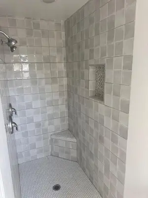 a gray tiled shower with a stool in a bathroom at LRG 1600sqft 4room 2 bath in a quiet neighborhood in Bakersfield
