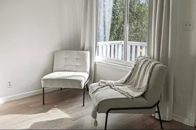 a living room with two chairs and a window at Modern Private 3B-2BA Home and Spacious Yard in Lancaster