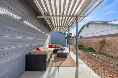 a pergola on the side of a building at Modern Private 3B-2BA Home and Spacious Yard in Lancaster