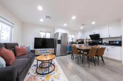 a living room with a couch and a table at Modern Private Room in Shared Home -Walk to USC in Los Angeles