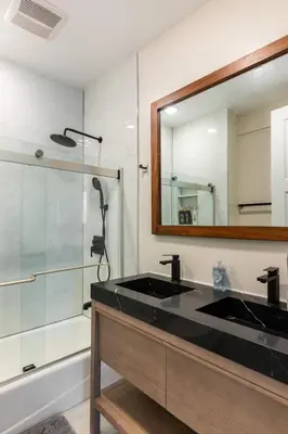 a bathroom with a black sink and a mirror at Spacious 5 BR Brand New House LAX in Inglewood
