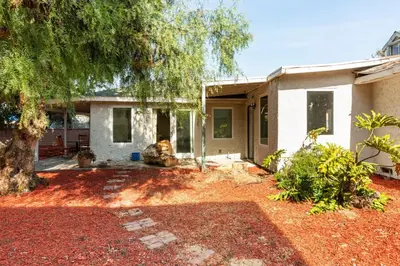 a house with a tree in front of it at Spacious 5 BR Brand New House LAX in Inglewood