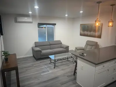 a living room with a couch and a table at Cozy Home Away From Home in Northridge Hospital Heliport