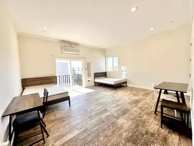 an empty room with tables and benches in a building at Lovely 3-bedroom house with AC in vibrant Los Angeles Near USC in Los Angeles
