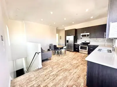 a large kitchen with a table and a dining room at Lovely 3-bedroom house with AC in vibrant Los Angeles Near USC in Los Angeles
