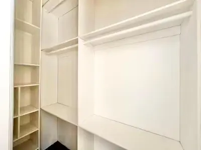 a white walk in closet with white shelves at Lovely 3-bedroom house with AC in vibrant Los Angeles Near USC in Los Angeles