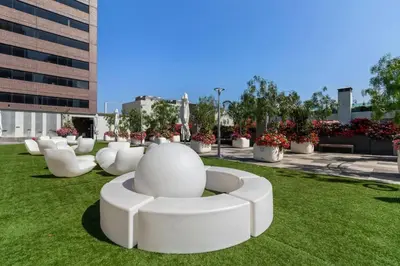 a park with white chairs on the grass at Stylish 2BR Loft with Top-Tier Amenities - 104 - GL in Glendale