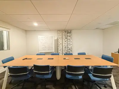 a conference room with a large wooden table and chairs at Stylish 2BR Loft with Top-Tier Amenities - 104 - GL in Glendale