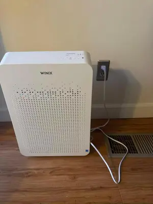 a white modem sitting on the floor next to a wall at 3-Bedroom Luxury Villa Near Dodger Stadium, Downtown LA Free Parking in Los Angeles