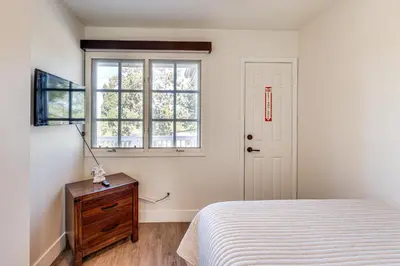 a bedroom with a bed and a window and a dresser at Beautiful Lake-View House Walk to Lake and Village! in Big Bear Lake