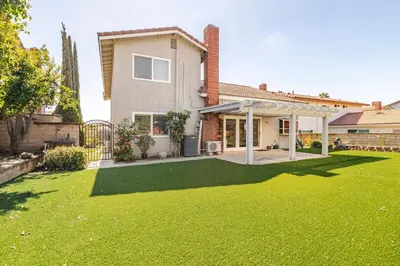 a house with a yard with a green lawn at Spacious 4-bedroom family house-20 mins to Disney Land in Rowland Heights