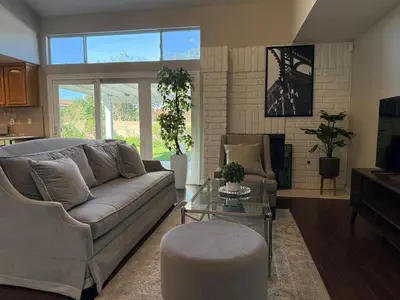 a living room with a couch and a table at Spacious 4-bedroom family house-20 mins to Disney Land in Rowland Heights