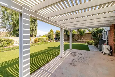 a white pergola on a patio with a yard at Spacious 4-bedroom family house-20 mins to Disney Land in Rowland Heights