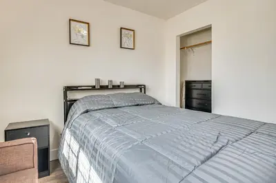 a bedroom with a bed and two pictures on the wall at Near Hospitals and Metrolink Access LA Getaway in Los Angeles