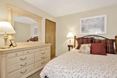 a bedroom with a bed with a dresser and a mirror at Summit Ski Resort Mountain View Condo - Walk to Snow Summit in Big Bear Lake