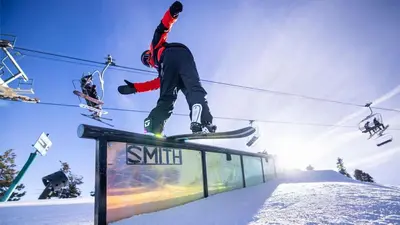 a person doing a trick on a snowboard on a rail at Summit Ski Resort Mountain View Condo - Walk to Snow Summit in Big Bear Lake