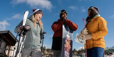 a group of three people standing with their skis at Summit Ski Resort Mountain View Condo - Walk to Snow Summit in Big Bear Lake