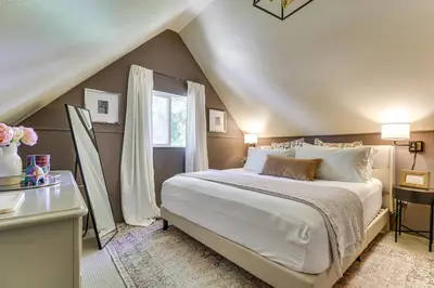 a bedroom with a large bed and a window at Hike, Ski, Relax Mtn Getaway in Lake Arrowhead in Lake Arrowhead
