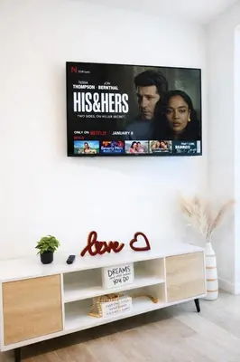 a living room with a tv on the wall at Heart of Hollywood Walk of Fame - Free Parking, Pool, Gym, Rooftop Views, centrally located, WIFI in Los Angeles