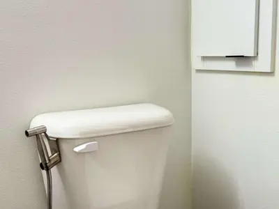 a bathroom with a white toilet in a room at Luxury Stay Near Disneyland With Pool Gym & Free Parking in Santa Ana