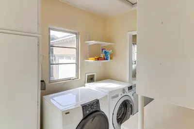 a laundry room with a washing machine and a window at Less Than 1 Mi to Universal Studios Home with Private Pool in Los Angeles