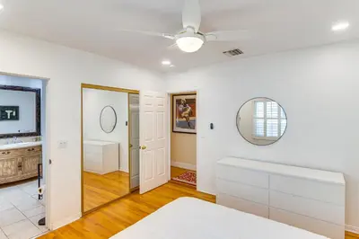 a bedroom with white walls and a ceiling fan at Less Than 1 Mi to Universal Studios Home with Private Pool in Los Angeles