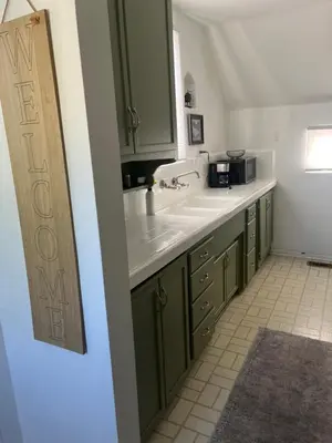 a kitchen with green cabinets and a white sink at The Magic castle Unit 1-2 in Santa Clarita