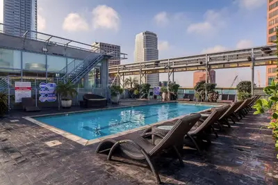a swimming pool with lounge chairs and a building at Relax and recharge in this elegant 2BR loft - 108 - GL in Glendale