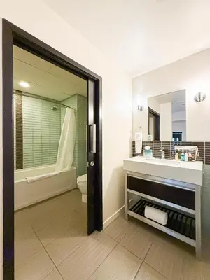 a bathroom with a sink and a toilet and a mirror at Relax and recharge in this elegant 2BR loft - 108 - GL in Glendale