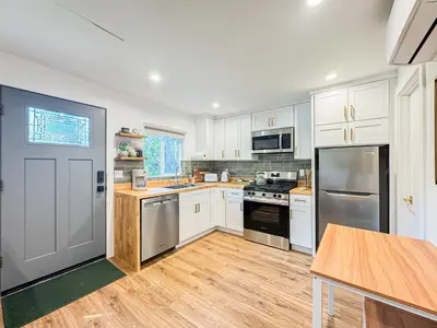 a kitchen with white cabinets and stainless steel appliances at Cozy Designer Guesthouse with Style - RE in Calabasas