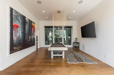 a living room with a pool table and a tv at 5BR Modern West Hollywood Retreat in Los Angeles