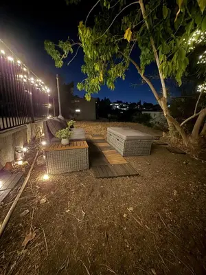 a backyard with a bench and a tree at night at Echo Park Spacious Two-Bedroom Apartment with Private Yard and Parking in Los Angeles