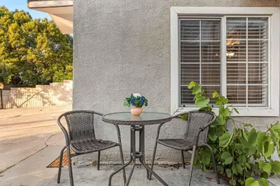 a patio table with two chairs and a vase on it at Echo Park Spacious Two-Bedroom Apartment with Private Yard and Parking in Los Angeles