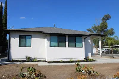 a white house with green shutters on it at Newly Renovated La Habra 3bed 2 Bath in La Habra