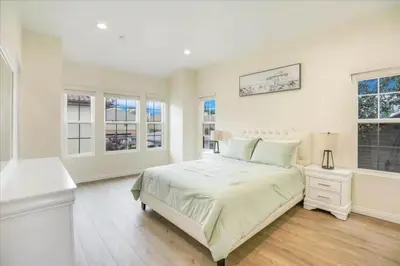 a white bedroom with a large bed and windows at Newly Built Pasadena Retreat Parking Great Location in Pasadena