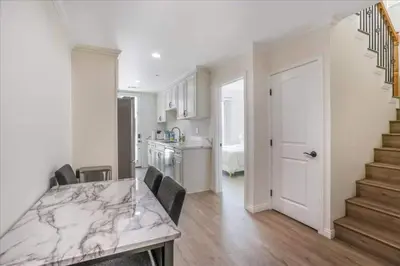 a kitchen with a marble counter top and a staircase at Newly Built Pasadena Retreat Parking Great Location in Pasadena