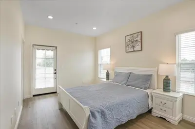 a white bedroom with a bed and two windows at Stylish Pasadena Stay Near Old Town & Rose Bowl in Pasadena