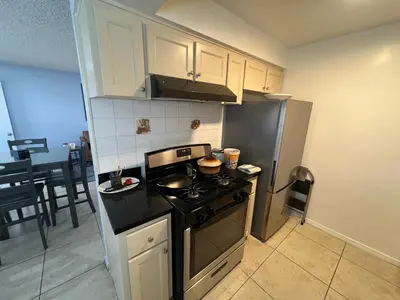 a kitchen with a stove and a refrigerator at 9621 San Juan - South Gate CA - Quick Drive to Hollywood & Beaches in South Gate