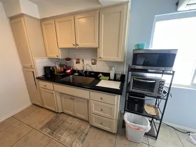 a kitchen with a sink and a microwave at 9621 San Juan - South Gate CA - Quick Drive to Hollywood & Beaches in South Gate