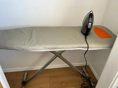 a bed in a room with an orange pillow on it at 9621 San Juan - South Gate CA - Quick Drive to Hollywood & Beaches in South Gate