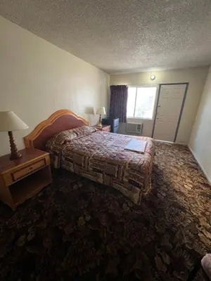 a hotel room with a bed and a window at York Motel in Los Angeles