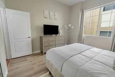 a bedroom with a bed and a television on a dresser at Quiet 1- bedroom condo near LAX, SoFi, and the Beach in Los Angeles